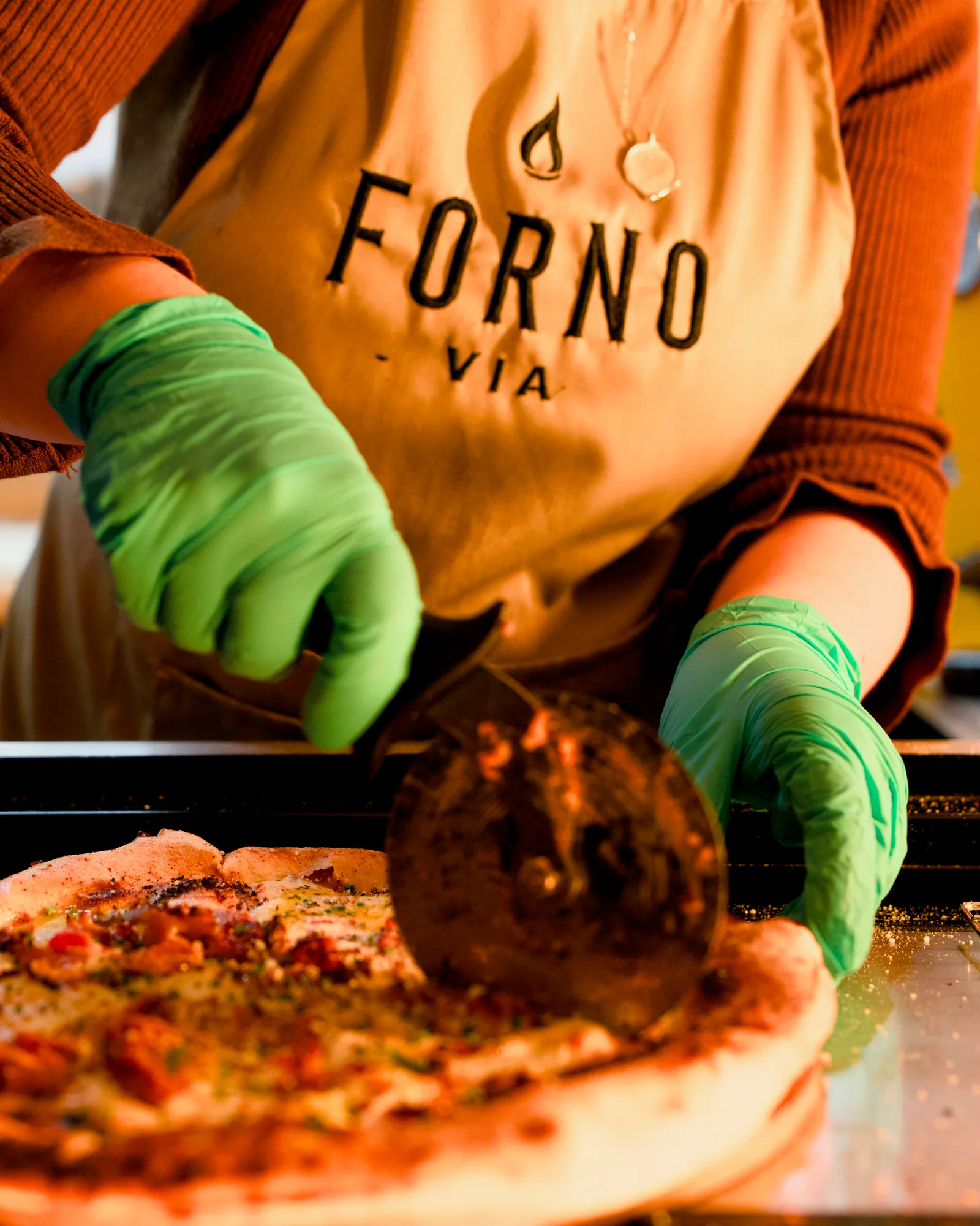 Pizza being finished live at the Forno Via mobile wood-fired oven